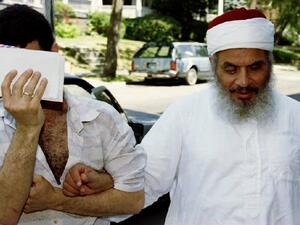 This file photo taken on June 25, 1993 shows Sheikh Omar Abdel-Rahman (R) entering his apartment building with an unidentified man after afternoon prayers at his mosque in Jersey City, New Jersey. (AFP/Mark D. Phillips)