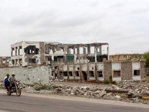 Yemeni ride past a damaged building outside of Aden. After a year of fighting, the destruction is widespread. (AFP/Saleh al-Obeidi) Yemeni ride past a damaged building outside of Aden. After a year of fighting, the destruction is widespread. (AFP/Saleh al-Obeidi)