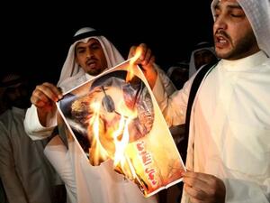 Kuwaiti protesters set ablaze a picture of Lebanese Shiite movement Hezbollah's chief Hassan Nasrallah during a protest in front the Lebanese embassy against Hezbollah's and Iran's involvement in Syria, in Kuwait city on June 11 (Yasser al-Zayyat / AFP)
