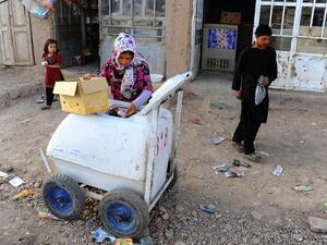An eight-year-old Afghan girl stocks her ice cream cart. She is one of thousands of Afghan children providing for their families. (AFP/File) An eight-year-old Afghan girl stocks her ice cream cart. She is one of thousands of Afghan children providing for their families. (AFP/File)