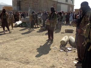 In this photograph taken on October 13, 2015, Afghan Taliban militants gather around parts of a US F-16 aircraft that was struck over in Sayid Karam district of eastern Paktia province. (AFP/File)