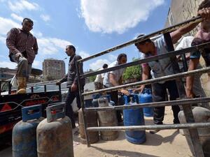 An Egyptian man loads gas cylinders onto a truck to be refilled at a warehouse in Cairo, Egypt, on September 11, 2016. (AFP/ File)