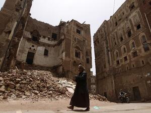 A man walks past rubble in Sanaa's historic district following airstrikes.  (AFP/Mohammed Huwais)