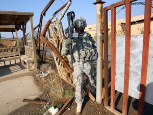 An American soldier walks through a fence at the Taji military base in northern Baghdad in 2014. (AFP/File)