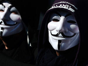 Illustrative photo of hacktivists in masks. (AFP/Aris Messinis)