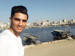 Assaf poses with the beautiful Port of Gaza behind him. (Facebook)