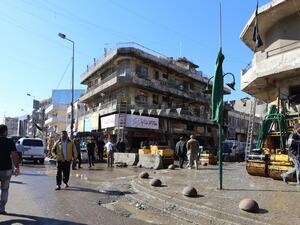 Iraqis clean the scene of a bomb explosion that targeted a group of workers at Tayaran square in Baghdad early on March 29, 2016. (AFP/Sabah Arar)