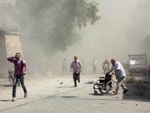 Syrian men react following a reported barrel bomb attack by Syrian government forces. (AFP/Karam al-Masri)