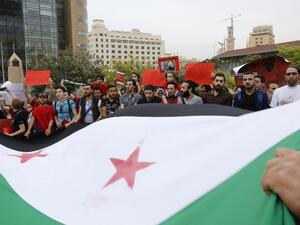 Syrian and Lebanese protesters wave the Syrian flag as they take part in a demonstration in front of United Nations offices in Beirut in solidarity with the civilians of Aleppo on May 1, 2016. (AFP/Anwar Amro) Syrian and Lebanese protesters wave the Syrian flag as they take part in a demonstration in front of United Nations offices in Beirut in solidarity with the civilians of Aleppo on May 1, 2016. (AFP/Anwar Amro)