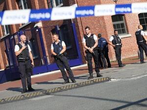 Belgian police secure the area around the police station where two officers were attacked with a machete on August 6, 2016. (AFP/Virginie Lefour) Belgian police secure the area around the police station where two officers were attacked with a machete on August 6, 2016. (AFP/Virginie Lefour)