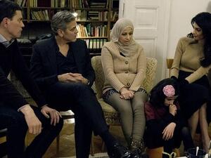 The Clooneys in conversation with a Syrian refugee in Berlin. (Munsif.tv)