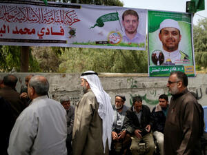 Palestinians gather in mourning outside the family home of 35-year-old professor and Hamas member Fadi Mohammad al-Batsh (AFP/File Photo)	
