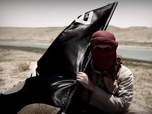 A Daesh militant carries his flag. (AFP/File)