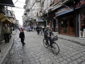 A man rides his bicycle in Damascus.  Recently, people in Damascus have been turning to bikes amidst heavy traffic and soaring transportation costs.  (AFP/Joseph Eid)