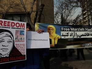 Iranians hold banners bearing messages that call for the release of US-born journalist Marzieh Hashemi, near the Swiss embassy in the capital, Tehran. (AFP/ File)