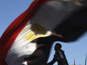 A demonstrator waves the Egyptian flag in Cairo's Tahrir Square on January 25, 2012, to mark the first anniversary of Egypt's uprising. (AFP/File)