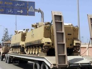 An Egyptian military truck carries armored personnel carriers en route to the Sinai Peninsula. (AFP/File)