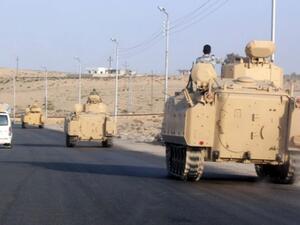 A convoy of Egyptian armoured vehicles heads along a road in El-Arish. (AFP/File)