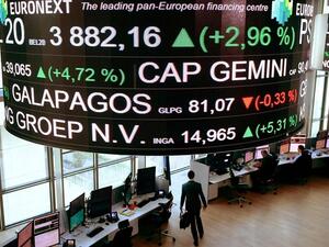 Share prices scroll across a screen hanging in a Paris stock exchange. (Eric Piermont/ AFP)