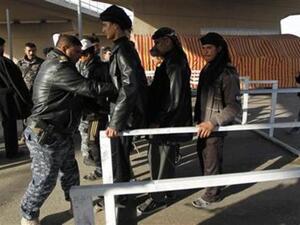 أفراد من الشرطة العراقية يفتشون زوارا من الشيعة في طريقهم الى مدينة كربلاء
