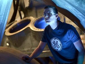 A worker looks at the 9HA Gas Turbine, at the General Electric (GE) plant in Belfort, France, on May 28, 2015. (AFP/ Frederick Florin)