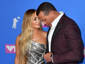 Jlo flaunted her fabulous figure in a plunging blue (Source: ANGELA WEISS / AFP ) 