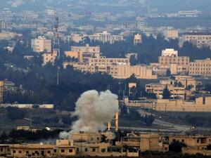 A picture taken on November 18, 2014 from the Israeli-annexed Golan Heights near the Quneitra border crossing with Israel shows smoke billowing from buildings in Syrian territory (AFP Photo/Jalaa Marey)
