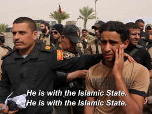 Major Salam of Iraq's Golden Division asks Sunni villagers if a certain youth is a Daesh member or not. (credit: VICE) 