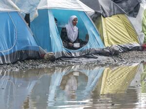A refugee eats her dinner in a tent after a short rain at a makeshift camp for migrants and refugees at the Greek-Macedonian border near the village of Idomeni on April 24, 2016. (AFP/Joe Klamar) A refugee eats her dinner in a tent after a short rain at a makeshift camp for migrants and refugees at the Greek-Macedonian border near the village of Idomeni on April 24, 2016. (AFP/Joe Klamar)