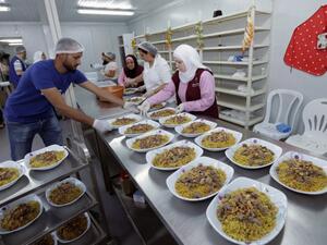 Lebanese and Syrians prepare dishes for an "Iftar" (fast breaking) dinner in the Lebanese capital Beirut on June 8, 2017. (Anwar Amro/AFP)