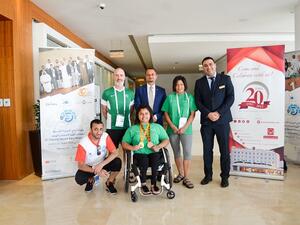 Yasser Moussa, Executive Assistant Manager, along with the Gold winner at the 9th Fazza Para Powerlifting Games 2018 and her coach.