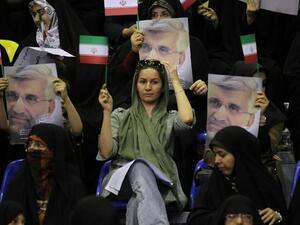 Supporters hold portraits of Iranian presidential candidate and lead nuclear negotiator Saeed Jalili during a campaign rally in Tehran on May 24 (Atta Kenare / AFP)