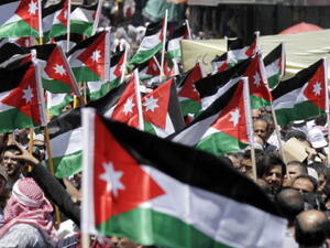 Protesters from the Islamic Action Front and other opposition parties hold up Jordanian national flags and shout slogans demanding political and economic reform, and access to cases of corruption, during a demonstration in Amman on June 14, 2013. [AFP]