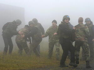 Apprentice chemical weapons inspectors of the United Nations and extras take part in an exercise during the education of OPCW inspectors at the German armed forces. [Getty Images]