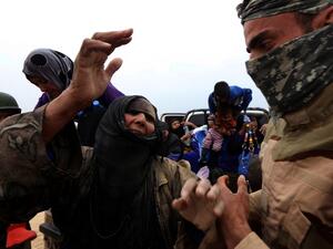 An Iraqi family fleeing the violence in the northern city of Mosul arrive at a Kurdish checkpoint in Makhmur, about 175 miles north of the capital Baghdad, on March 26, 2016. (AFP/Safin Hamed)