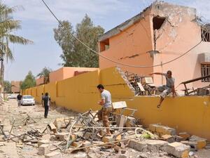Iraqi residents inspect damages on May 7, 2014, following shellings by government forces in an area of Fallujah held by anti-government fighters. (AFP/Saddam Hussein)