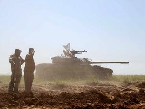 Iraqi Shiite fighters from the Popular Mobilisation units gather in position during clashes in the village of al-Bashir, still controlled by the Islamic State jihadist group, on April 5, 2016. (AFP/Mohammed Sawaf)