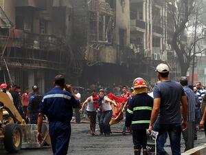 Iraqis evacuate a body from the site of a suicide car bombing claimed by the Islamic State on July 3, 2016 in Baghdad's central Karrada district. (AFP/ File)