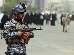 An Iraqi soldier stands guard on a main road in Baghdad as Shiite Muslim pilgrims arrive on June 2 (Ahamd al-Rubaye / AFP)