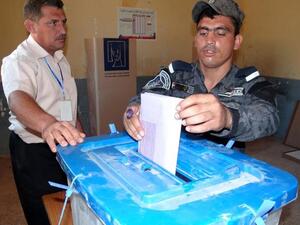 An Iraqi policeman casts his ballot in Ramadi on June 17, 2013 as security forces vote in provincial polls ahead of the rest of Iraqis in the Anbar province. Iraq held provincial elections in April except in six provinces, including Anbar and Nineveh, where polls were delayed because authorities said security could not be guaranteed (Azhar Shallal / AFP)