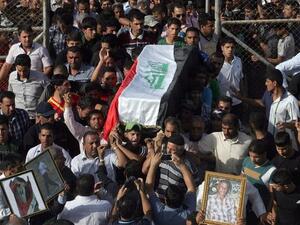 Family and friends carry the coffin of Iraqi Karbala Club football coach Mohammad Abbas, during his funeral in the central Iraqi city of Karbala. Abbas and some team members were allegedly beaten by security forces (AFP)
