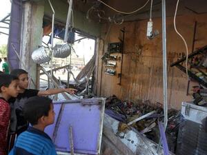 Children look at the damage following a car bomb in the Shuala area of eastern Baghdad, on July 3, 2013, following several attacks the previous day (AFP)
