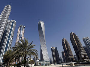 The Cayan tower (C), the world's tallest twisted tower stands at Dubai's Marina on June 11, 2013 in the United Arab Emirates, UAE. (AFP/KARIM SAHIBSAHIB)