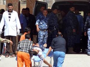 Iraqi medics wheel a man to hospital after demonstrators and security forces near Kirkuk (Marwan Ibrahim/AFP)