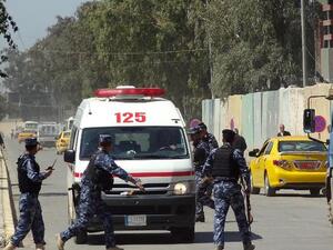Iraqi soldiers surround an ambulance after deadly clashes at a Sunni protest camp in Hawija, near Kirkuk
