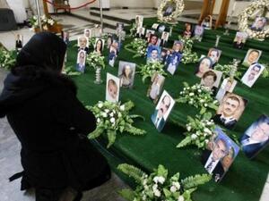 عراقية مسيحية تصلي امام صور ضحايا الهجوم على كنيسة سيدة النجاة في بغداد