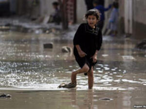 فتاة عراقية تحاول الهروب من زخات المطر