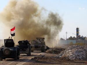 Iraqi pro-government forces drive their armored vehicles in the Jwaibah area, on the eastern outskirts of Ramadi, on February 8, 2016. (AFP/Moadh al-Dulaimi)
