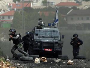 Israeli security forces take aim during clashes with Palestinian protesters following a weekly demonstration against the expropriation of Palestinian land by Israel in the village of Kfar Qaddum, near Nablus, in the occupied West Bank, on April 8, 2016. (AFP/Jaafar Ashtiyeh)