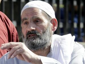 Omar Othman, the father of radical Islamist cleric Abu Qatada, stands outside the state security court in Amman on July 7 (AFP)